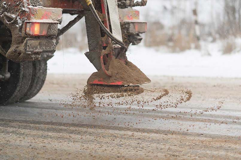 JPS winter gritting vehicle treating a frosted surface